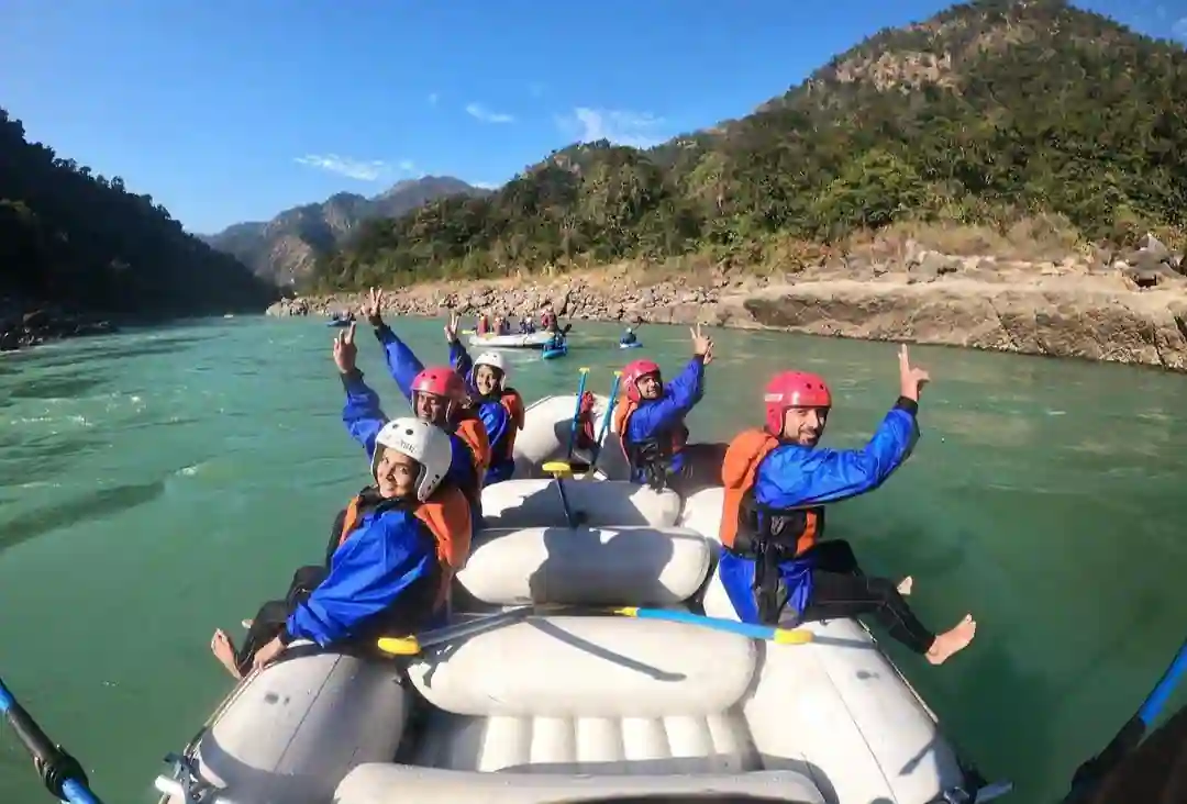 Three rating boats filled with rafters smiling in the camera