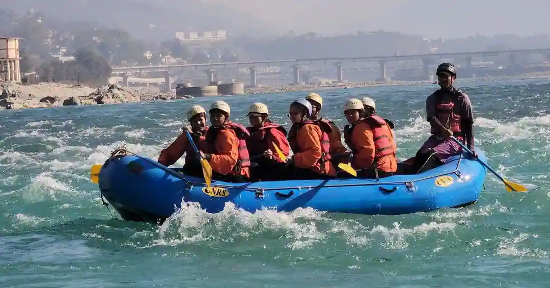 A group of 7 people along with their guide rafting in the Rishikesh