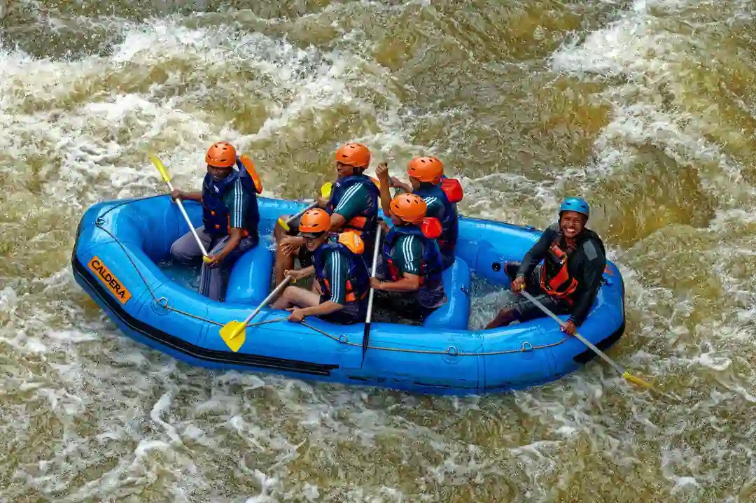 Six peoples rafting in the middle of river