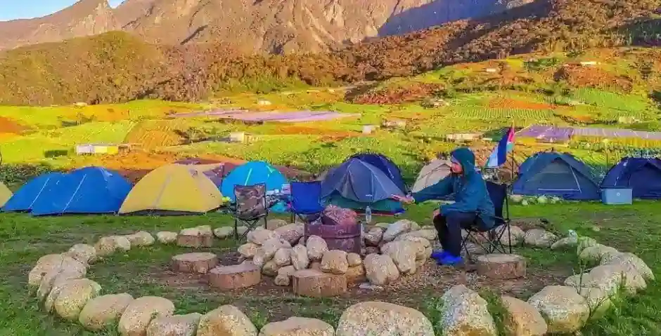 A man camping in Rishikesh inside a circle made of stones