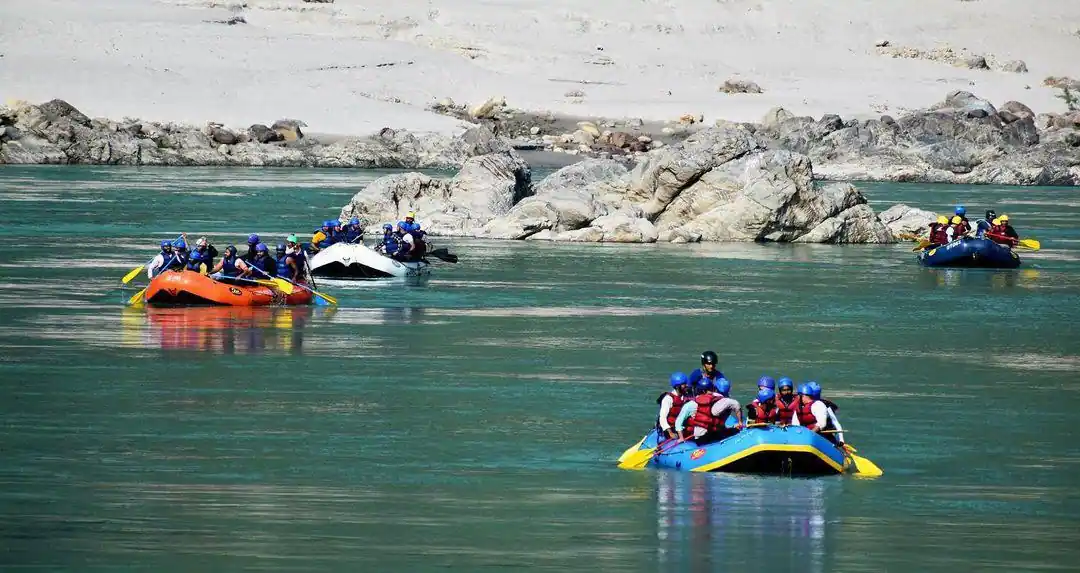 4 rafting boats in the middle of Ganga river