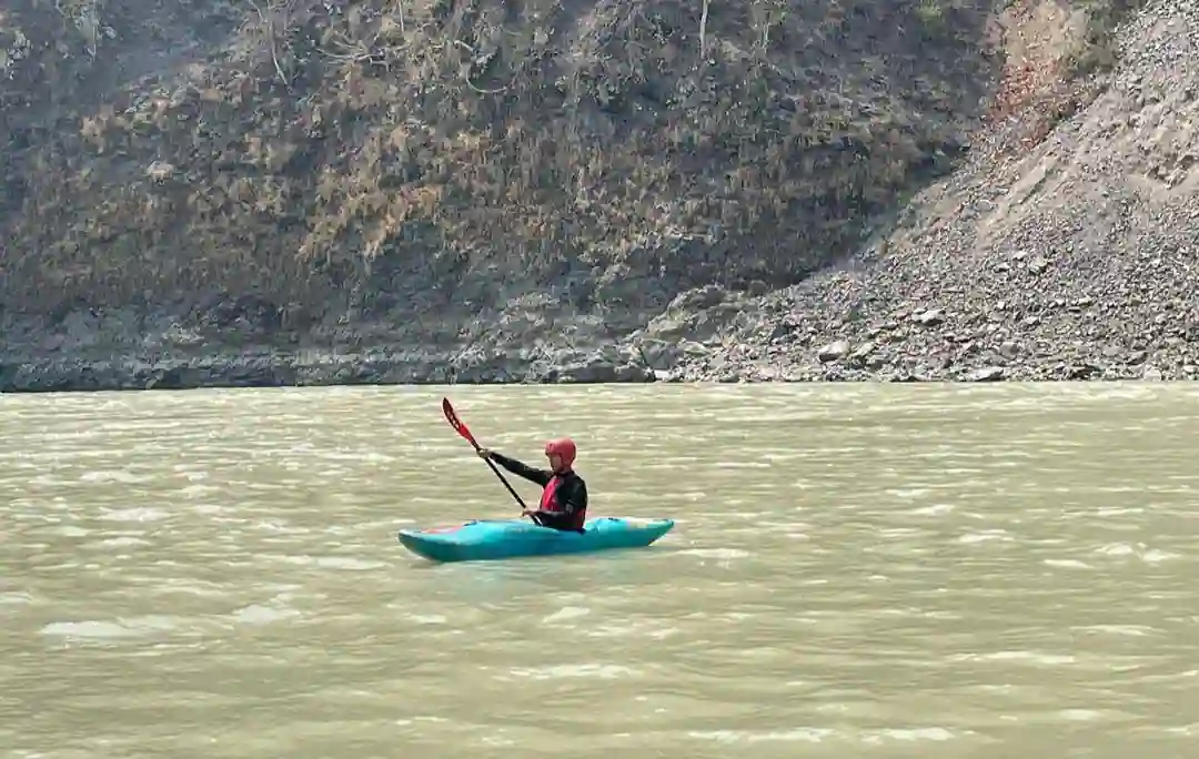 A man kayaking in the River Ganga all alone.