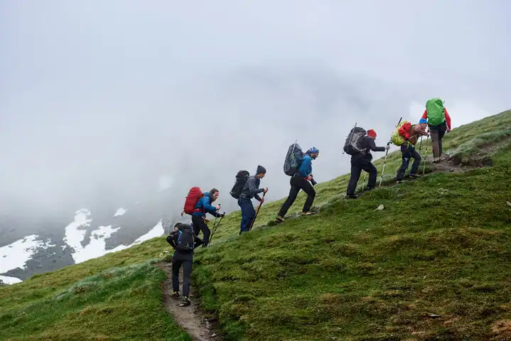 A group of 7 peoples hiking on a mountain