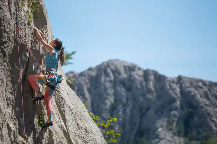 A woman rock climbing on a cliff