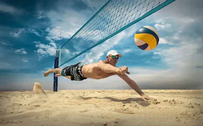 A man trying to hit the volleyball in beach