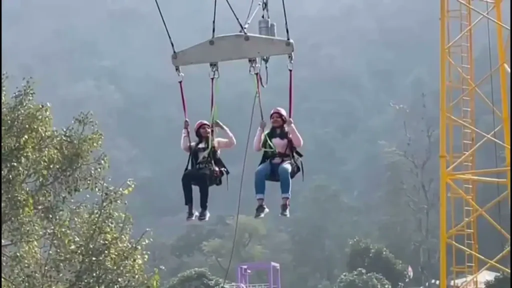 Two women trying giant swing in Rishikesh