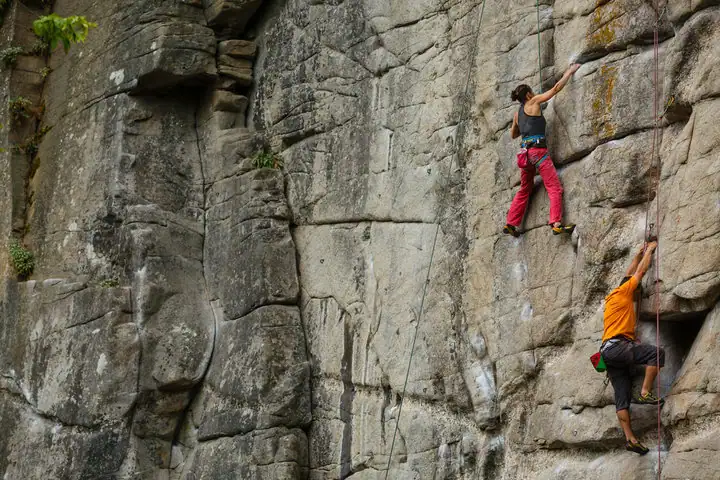 Two people rock climbing