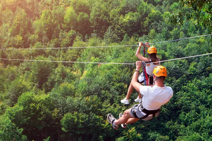 A couple zip lining 