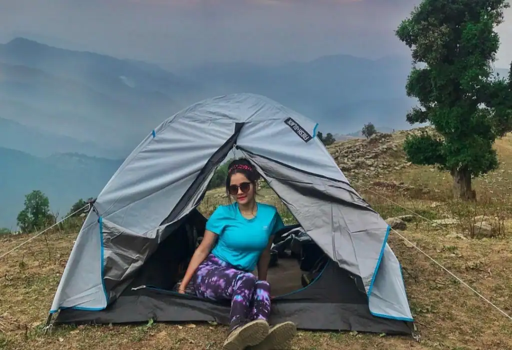 A woman camping amid mountain