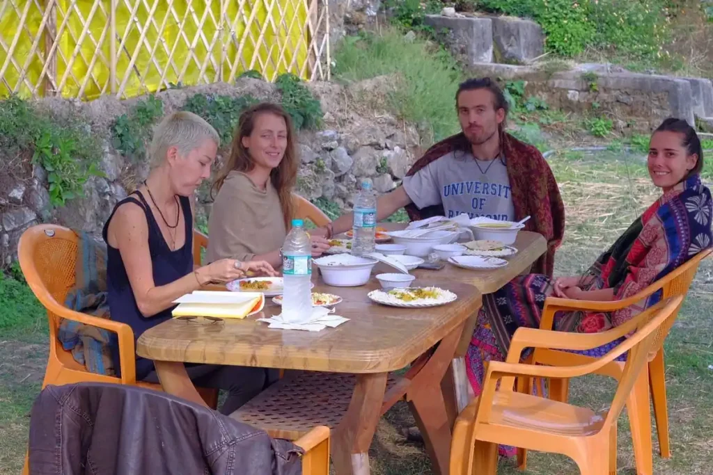 A group of people having food inn Uddibaba Agro Camp